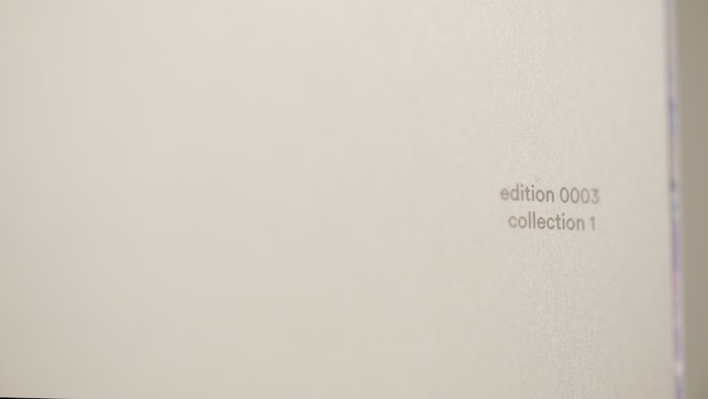 a close up of a white wall with the word collection on it