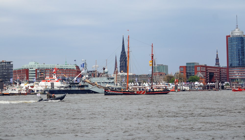 a large boat is in the water in front of a city