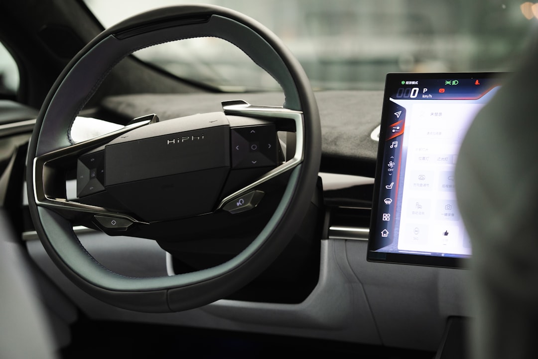 a car dashboard with an electronic device in the center, HiPhi Z steering wheel