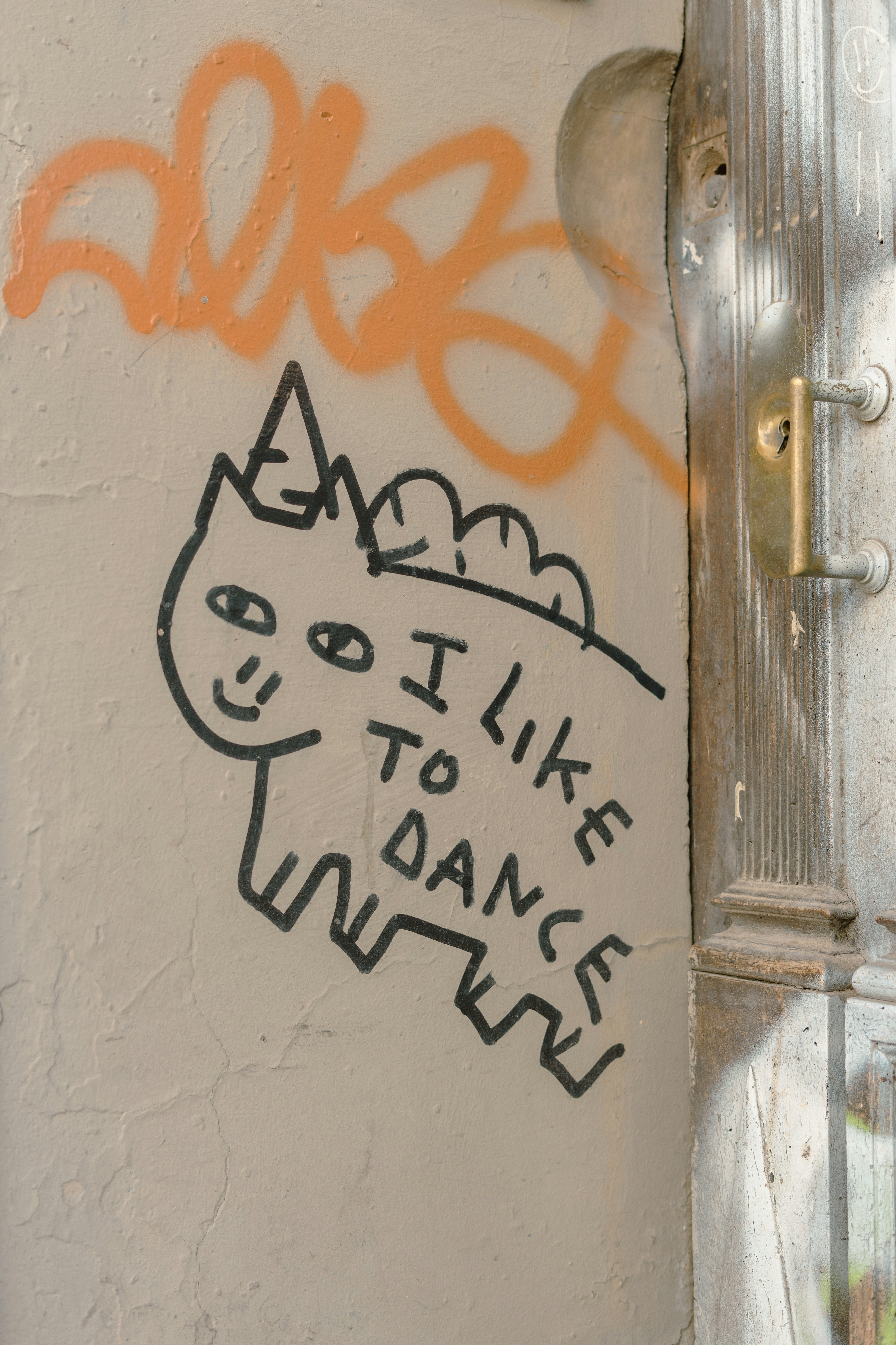 graffiti on the side of a building near a door