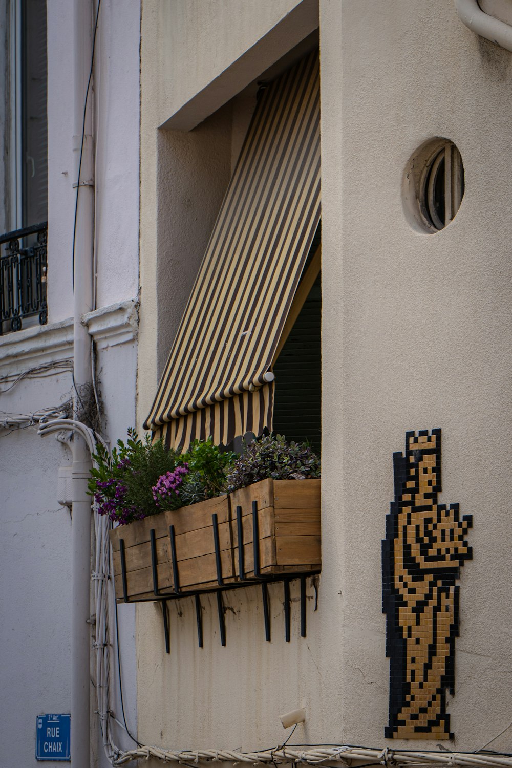 a window with a planter on the outside of it