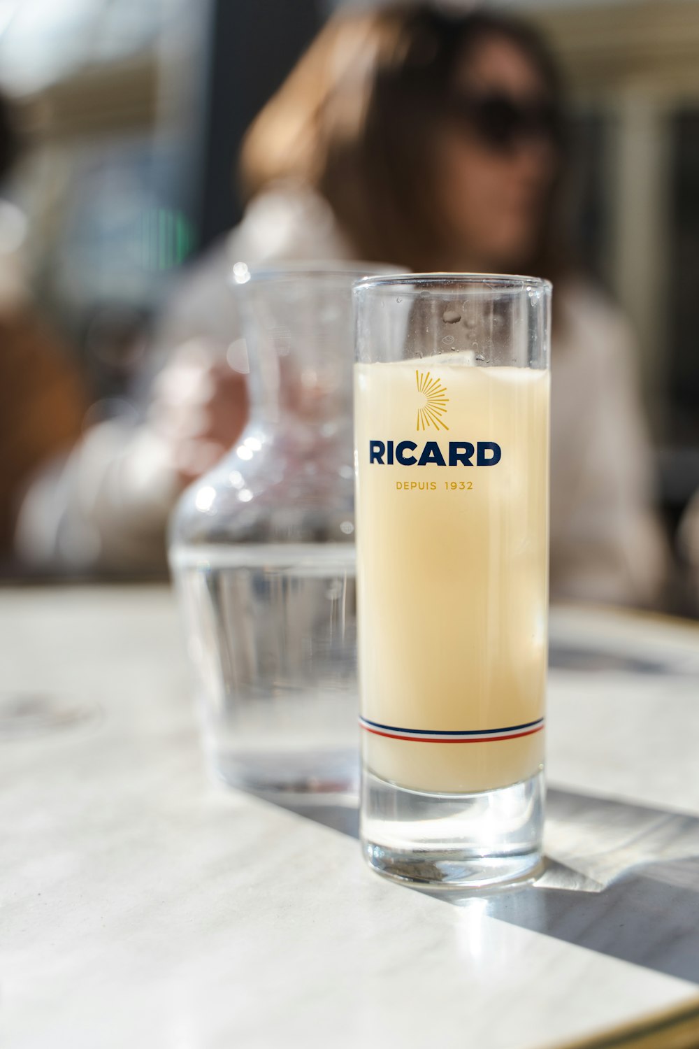 a glass of liquid sitting on top of a table