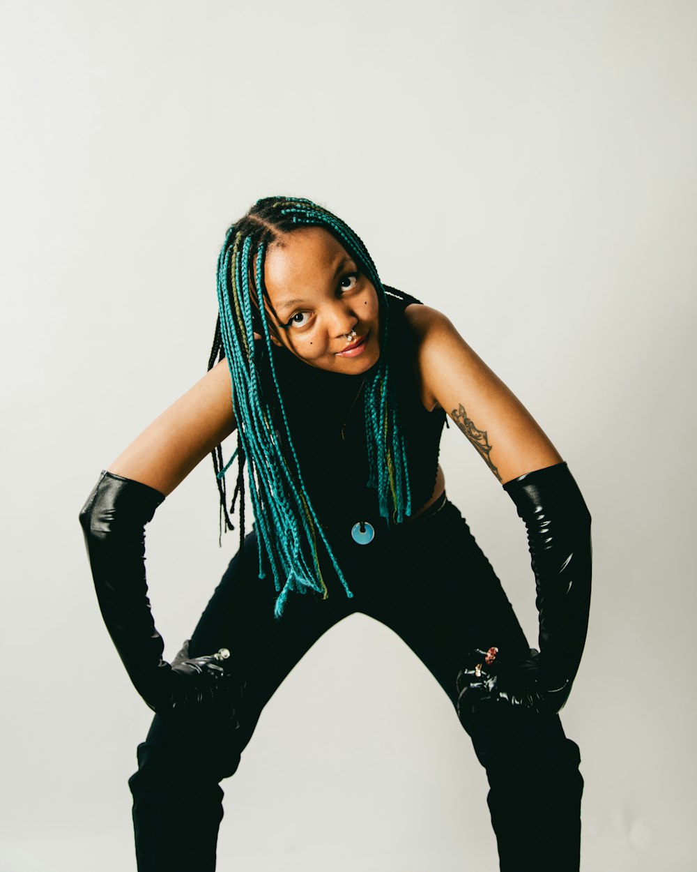 a woman with green dreadlocks posing for a picture