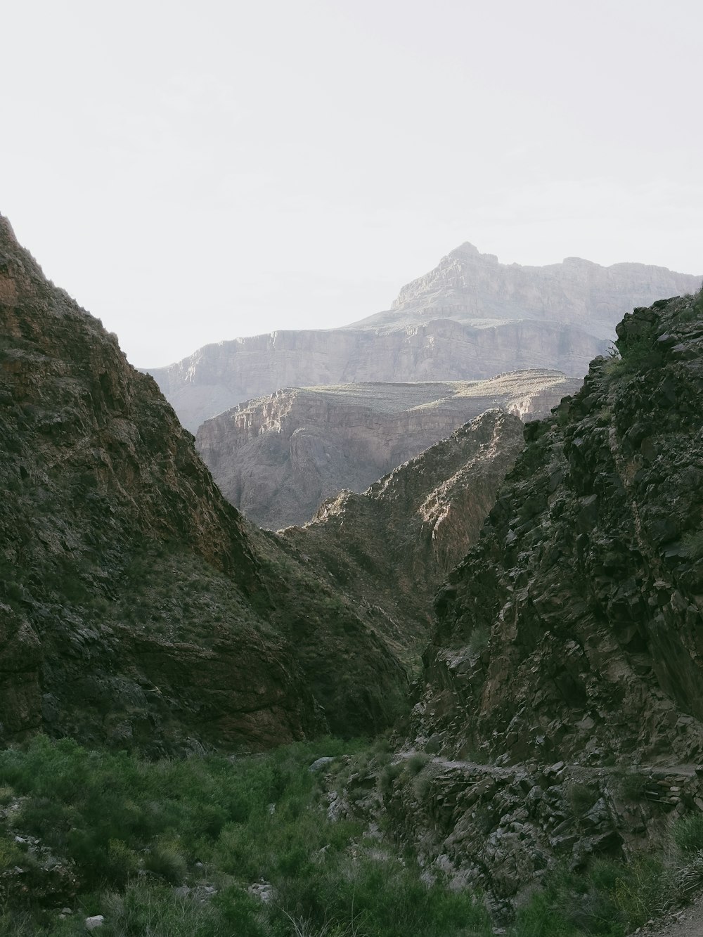 a man riding a horse through a canyon