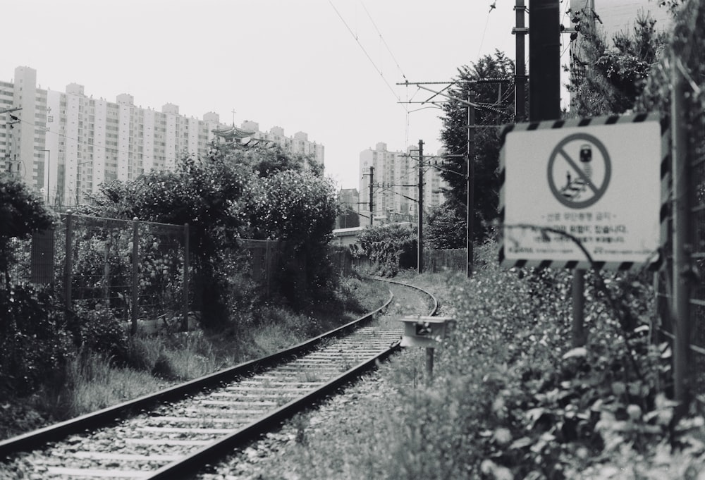 a train track with a no parking sign next to it