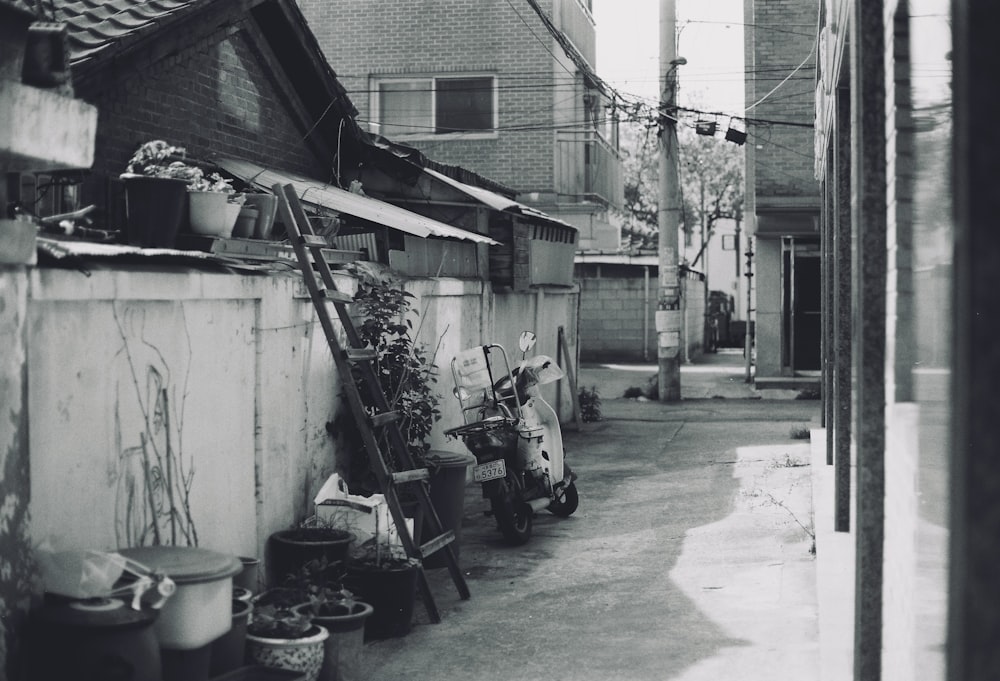 a black and white photo of a narrow alleyway