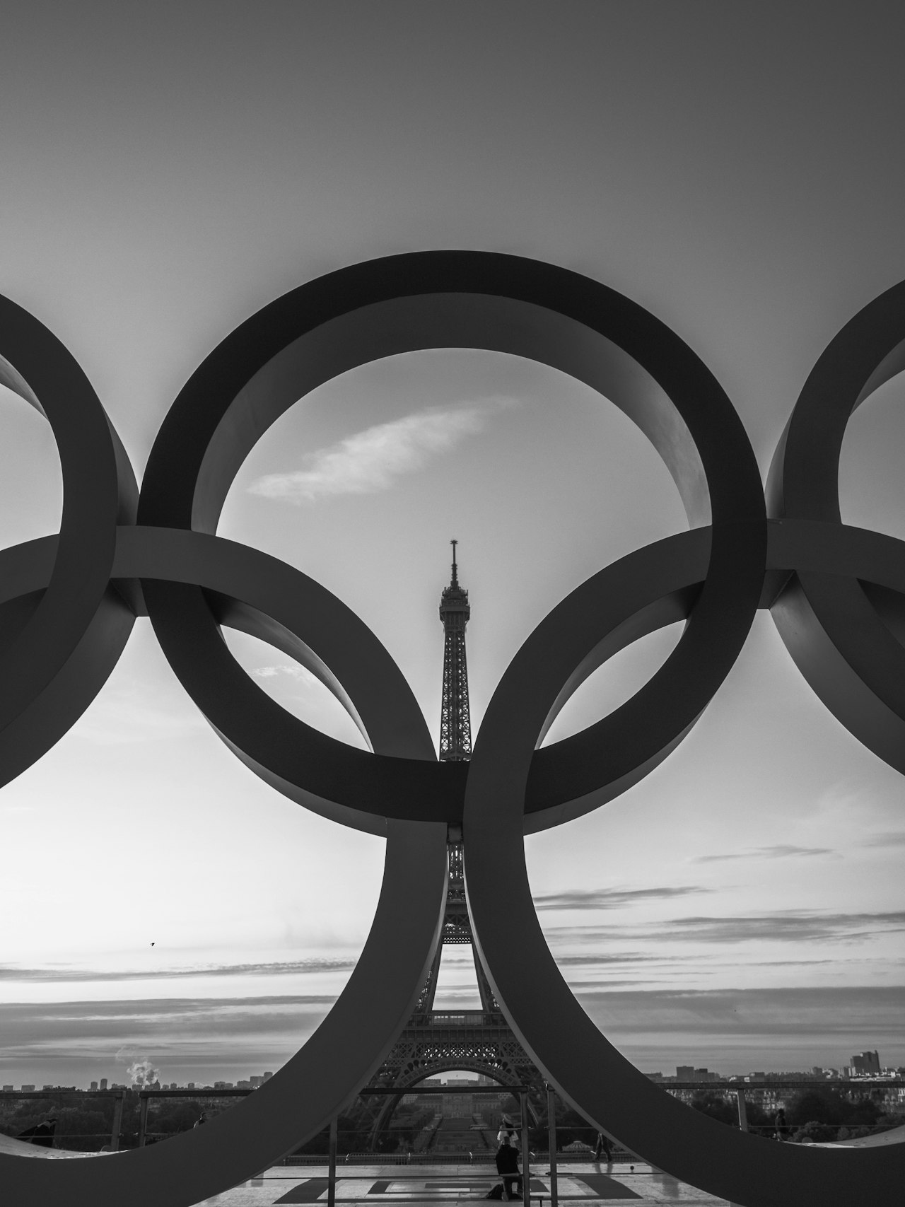 the olympic rings in front of the eiffel tower