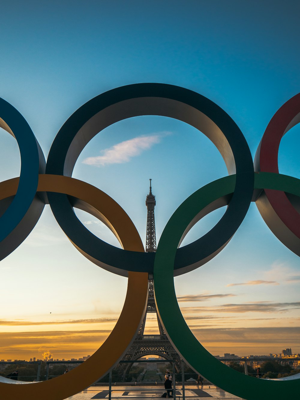 the olympic rings in front of the eiffel tower