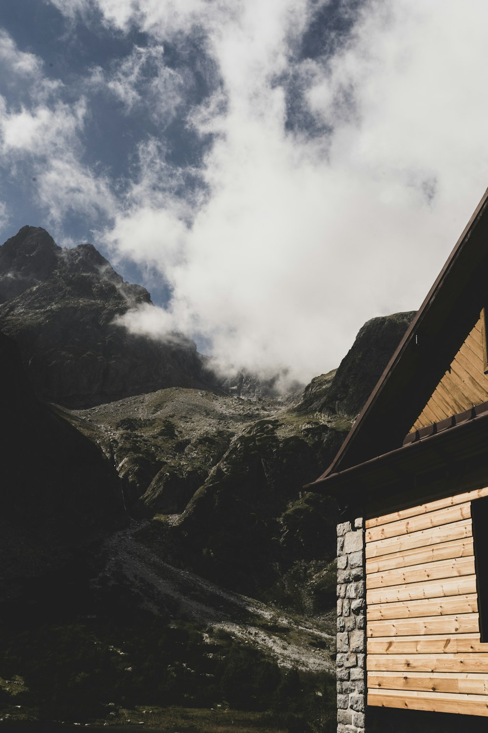 a wooden cabin with a mountain in the background