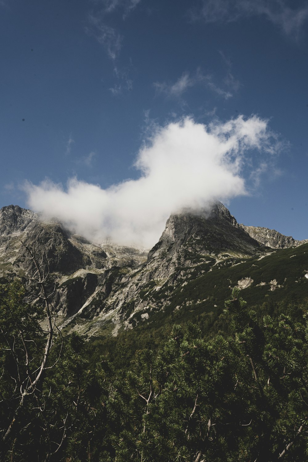 a view of a mountain with a cloud in the sky