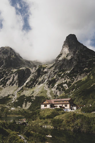 A serene Uttarakhand mountain lodge nestled among pine trees at sunset.