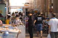 A busy market scene where locals discuss concerns with attentive expressions.