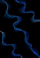 Close-up of delicate sound waves rippling gently across a midnight blue background.