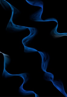 A close-up shot of electric blue soundwave patterns glowing softly against a charcoal background.