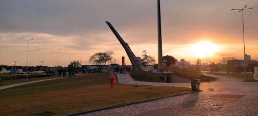 Sunset view over the landscaped park with historic monuments in the background