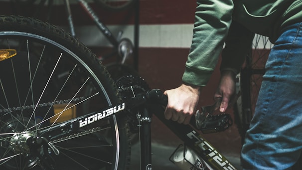 a close up of a person holding a bike