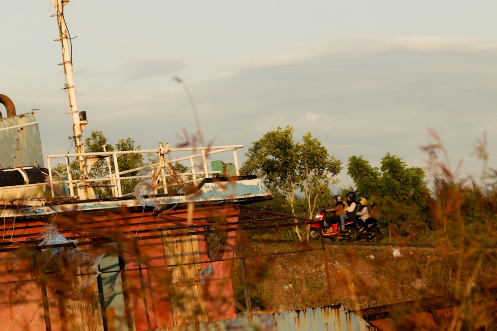 a rusted out building with a motorcycle parked on top of it