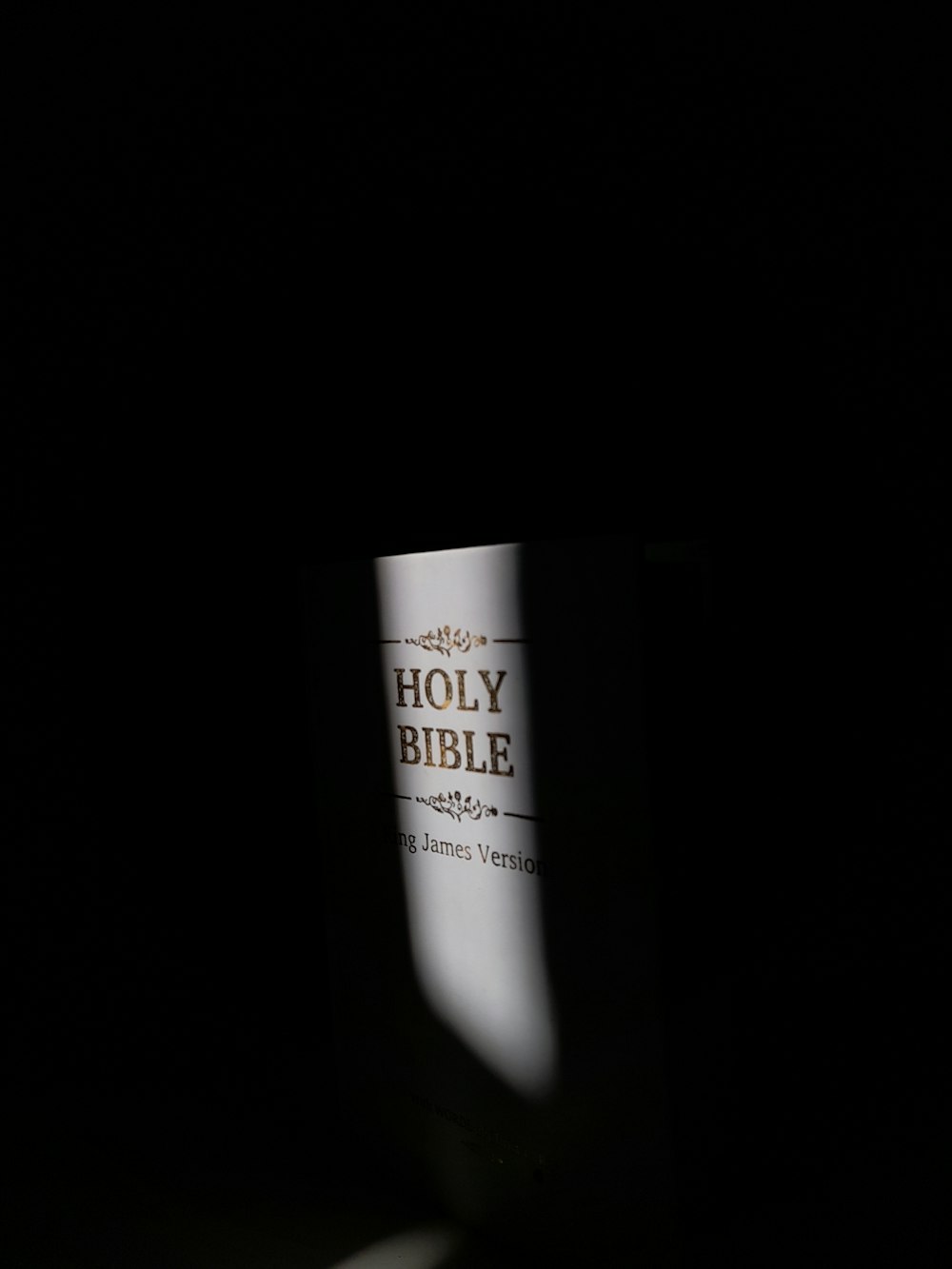 a bible in the dark on a table