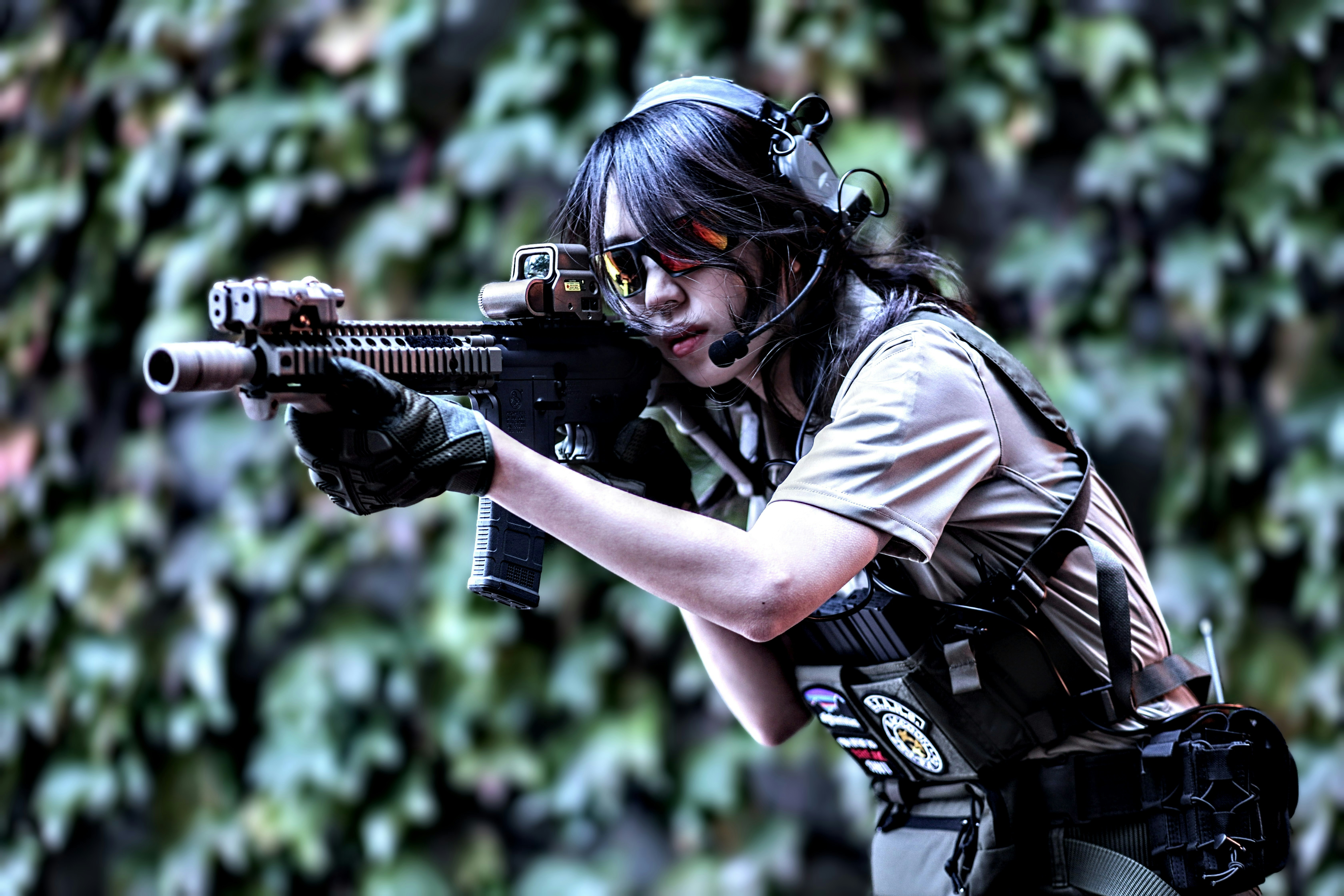 a woman with a gun in her hand