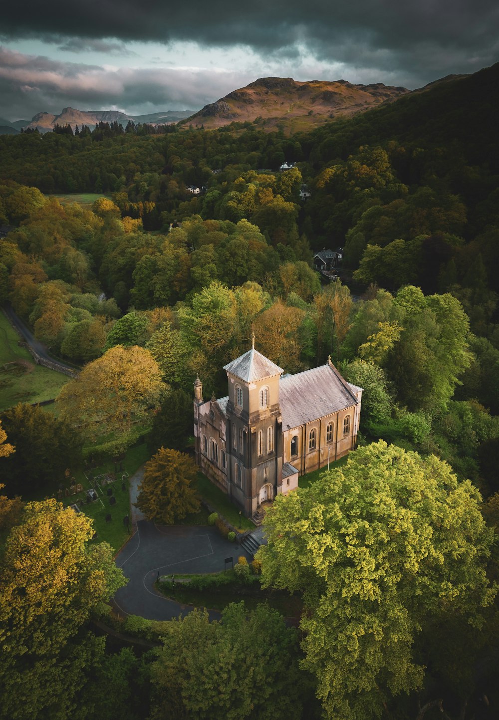 an aerial view of a building surrounded by trees