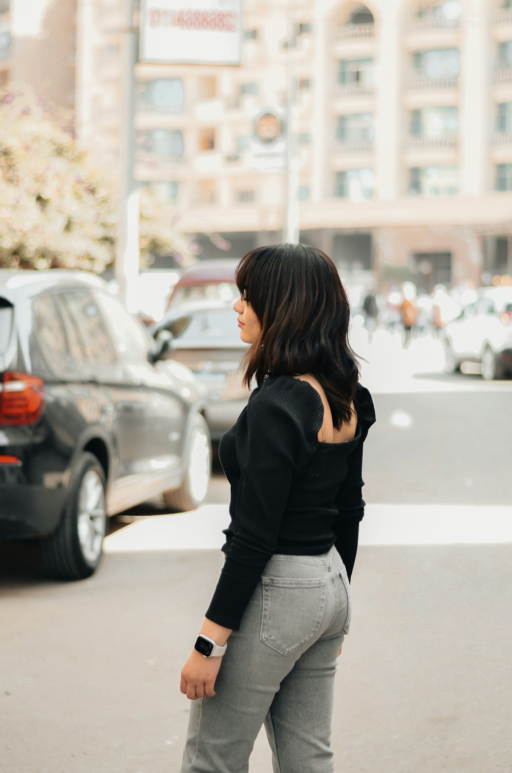 a woman standing in the middle of a street