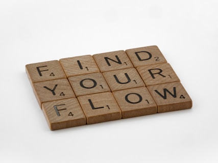 a scrabbled wooden block with the words find your flow on it