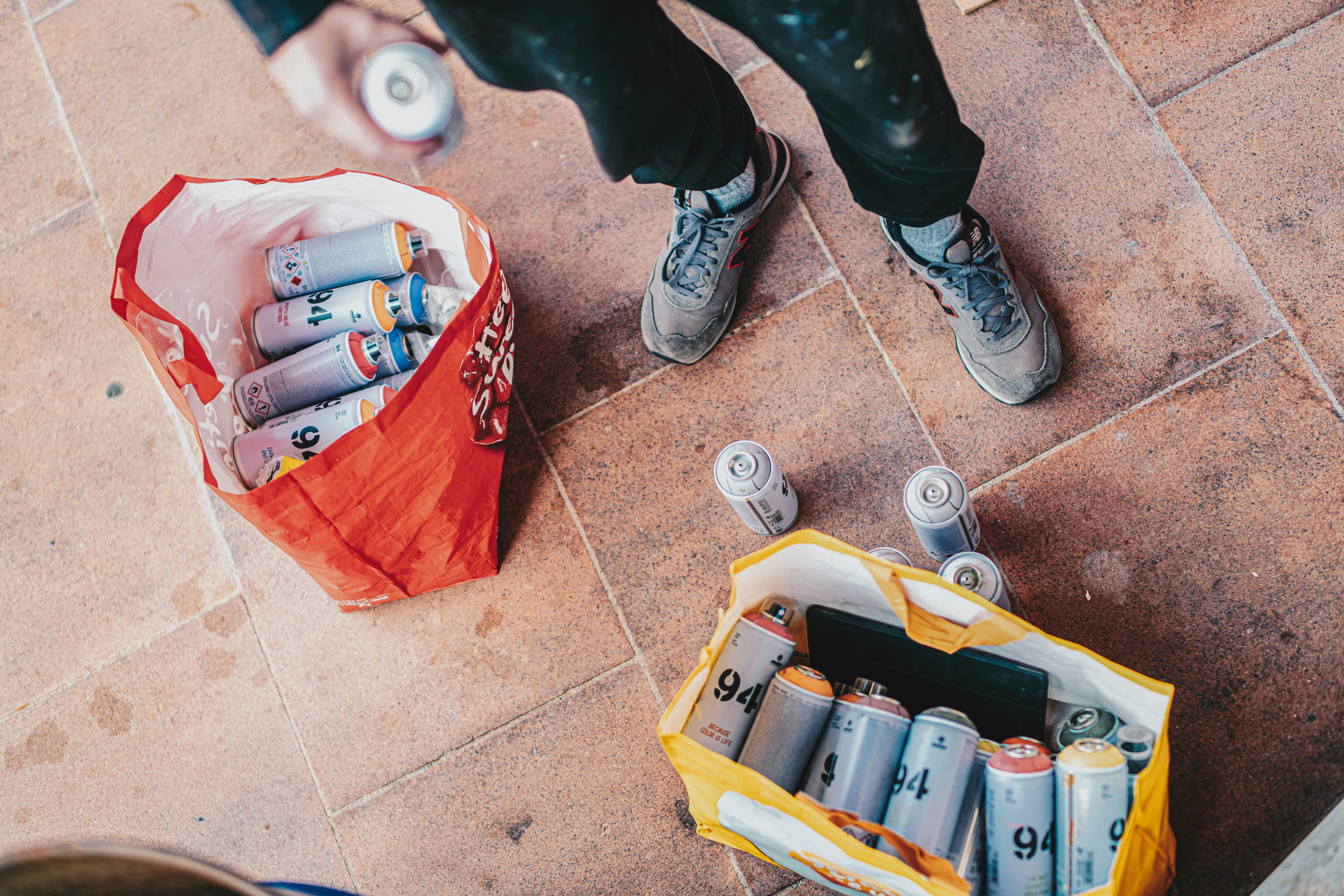 a person standing next to a bag of batteries