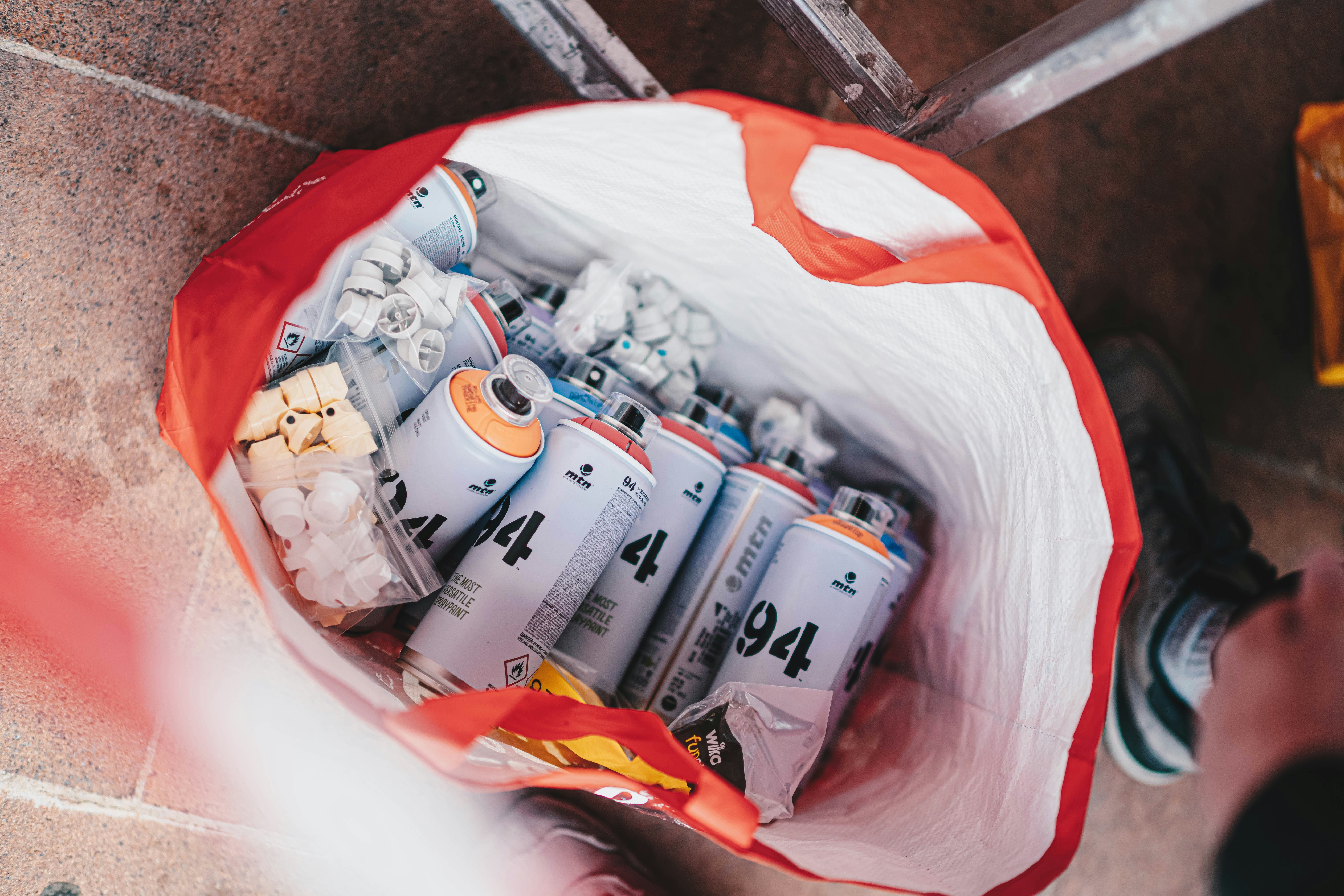 a person holding a bag full of cans of soda