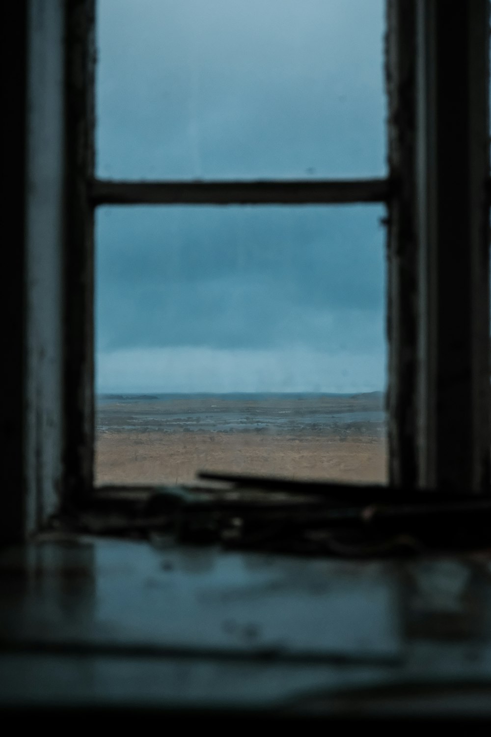 an open window with a view of a beach