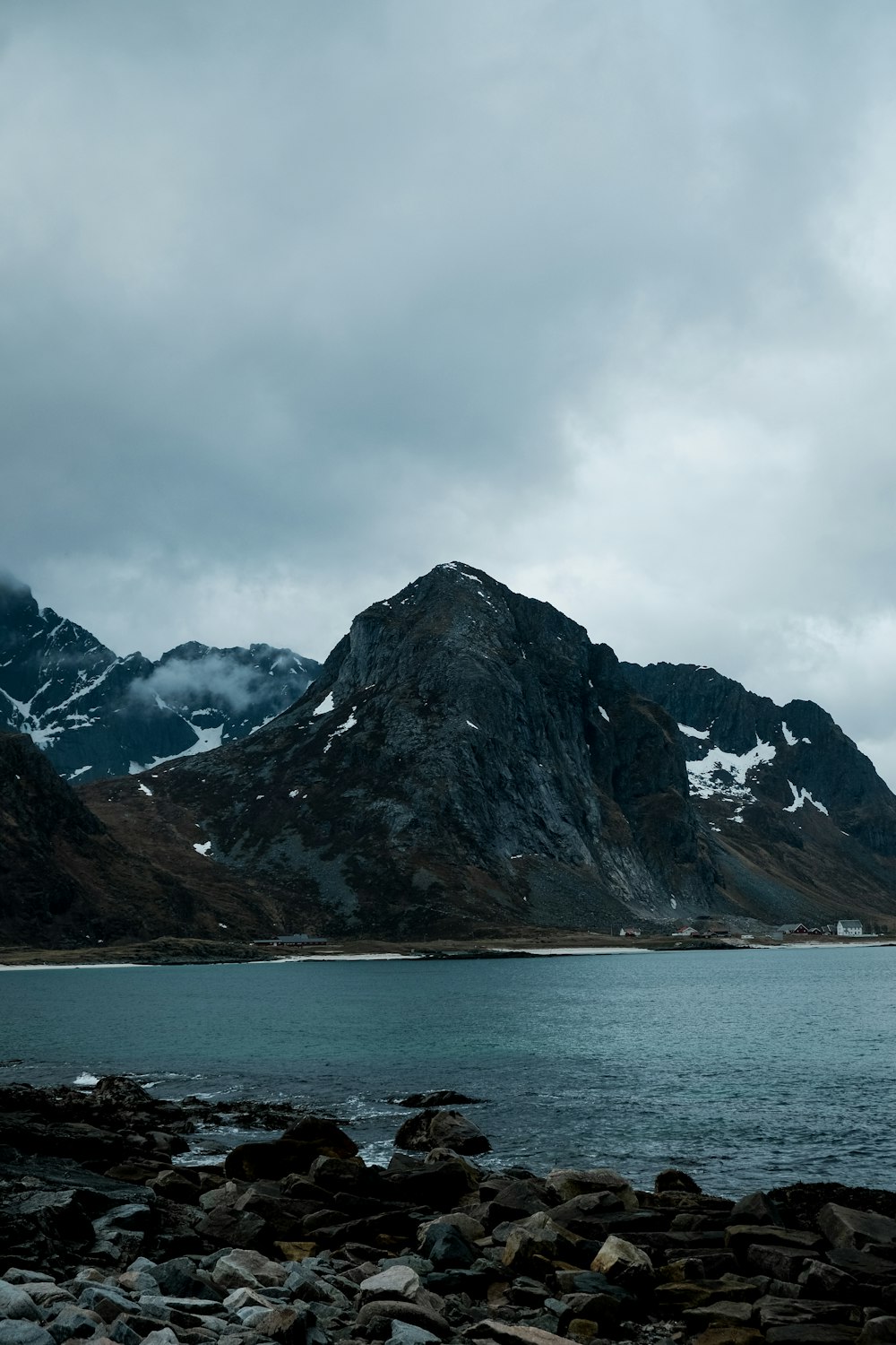 a mountain range with a body of water in the foreground