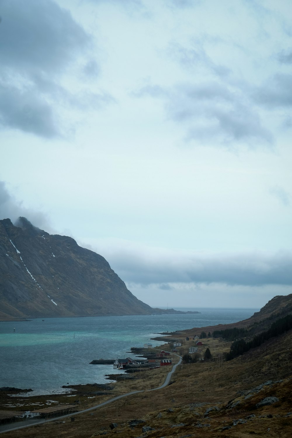 a view of a body of water with mountains in the background