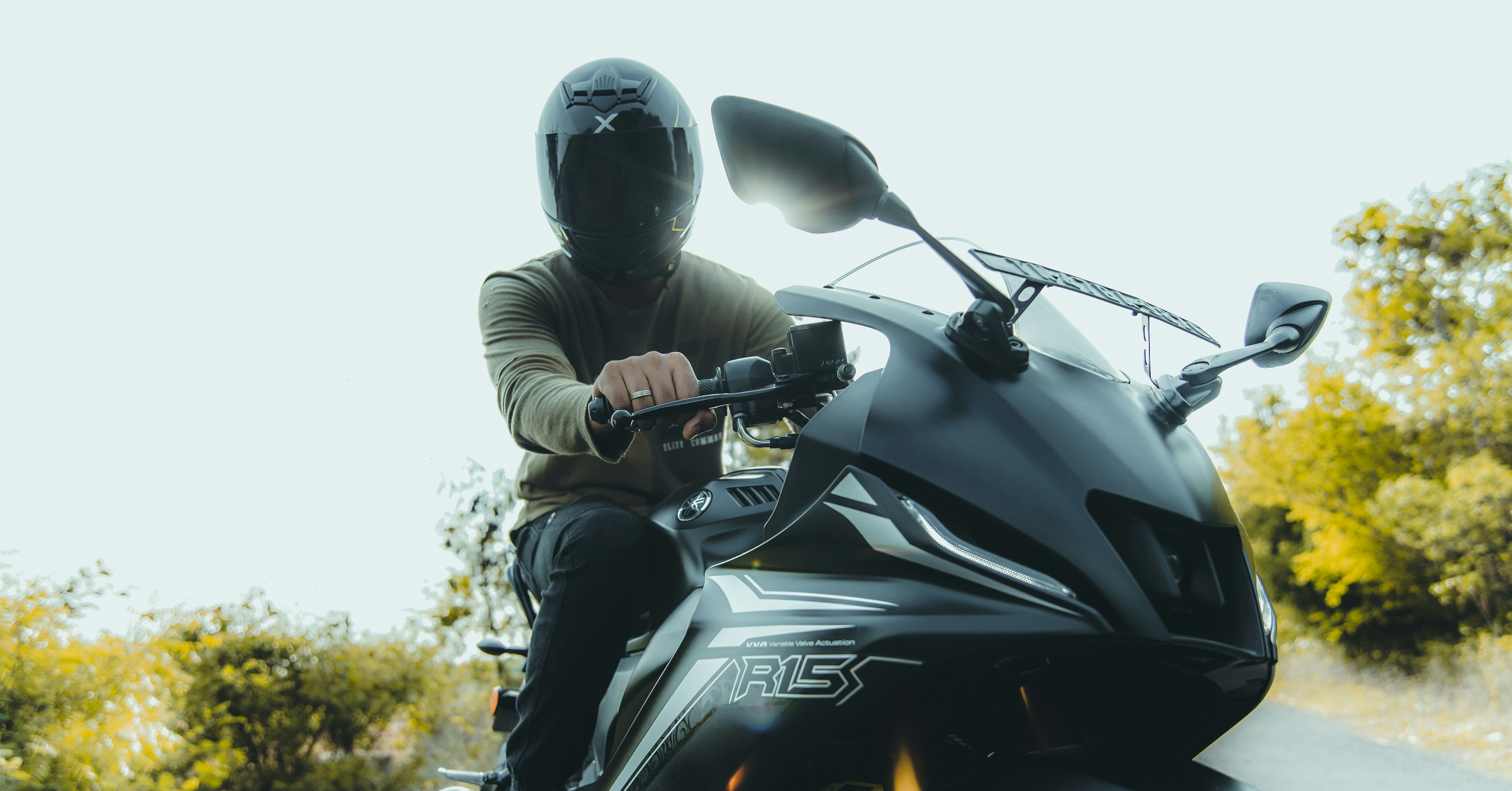 a man riding a motorcycle down a curvy road
