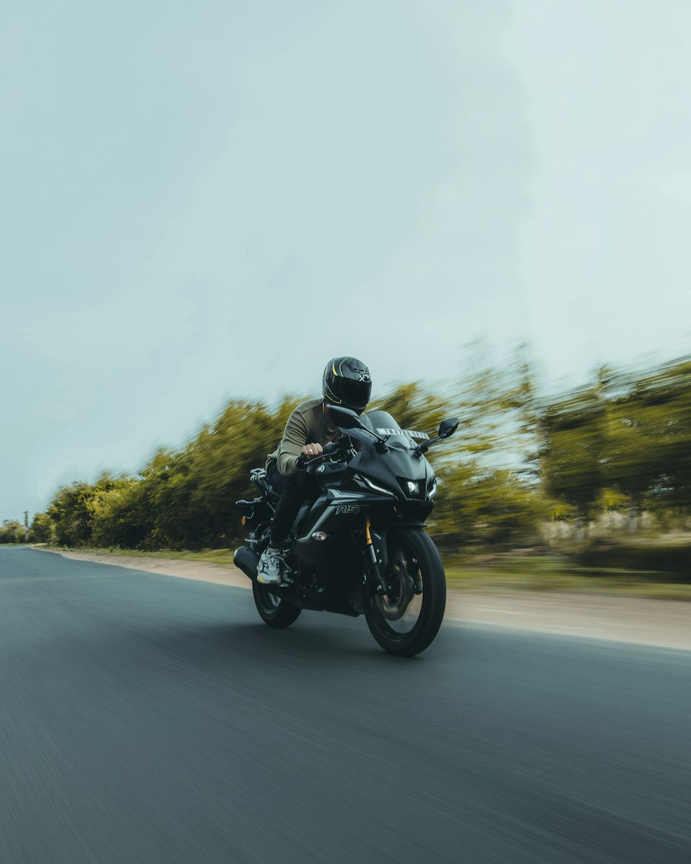 a man riding a motorcycle down a curvy road