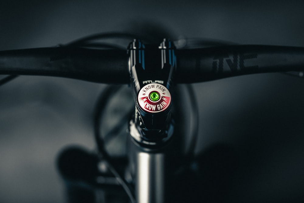 a close up of a bike handlebar with a green and red sticker on