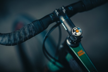 Close-up of a customized bike handlebar with colorful grips and accessories.