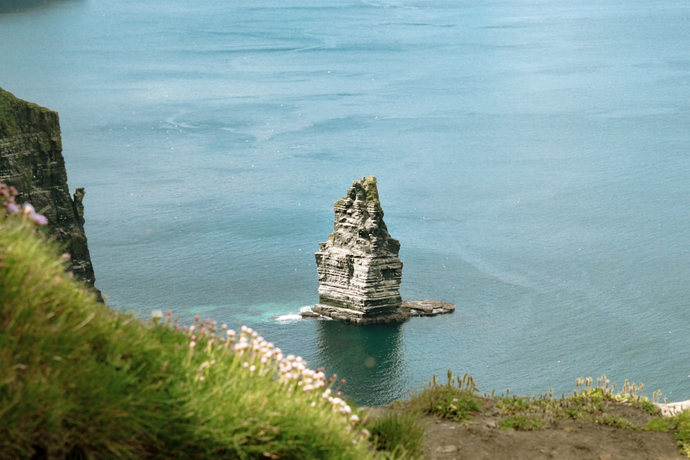 a rock outcropping in the middle of a body of water