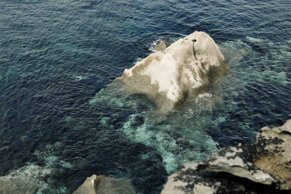 an iceberg in the middle of a body of water