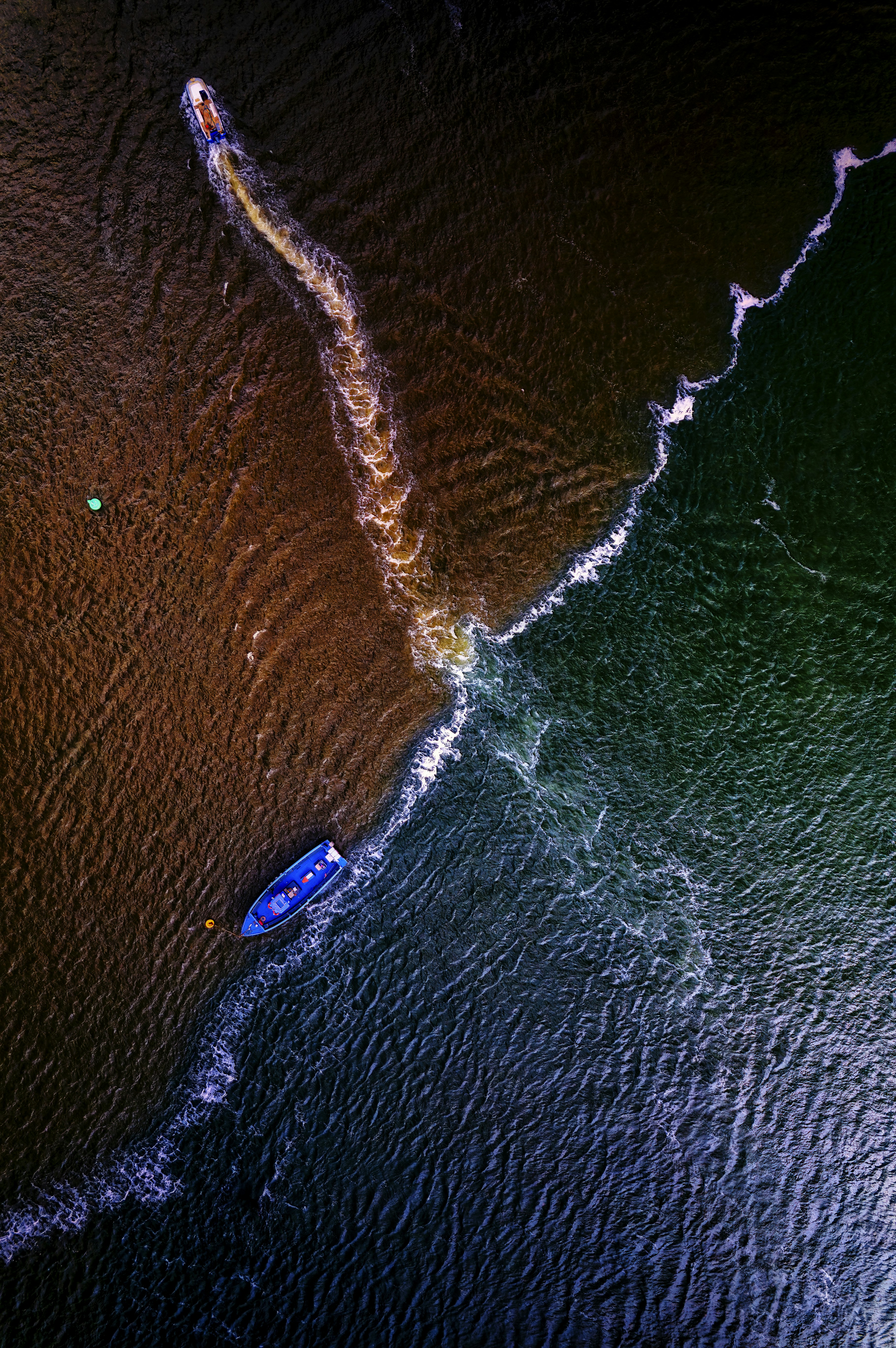 an aerial view of a boat in the water