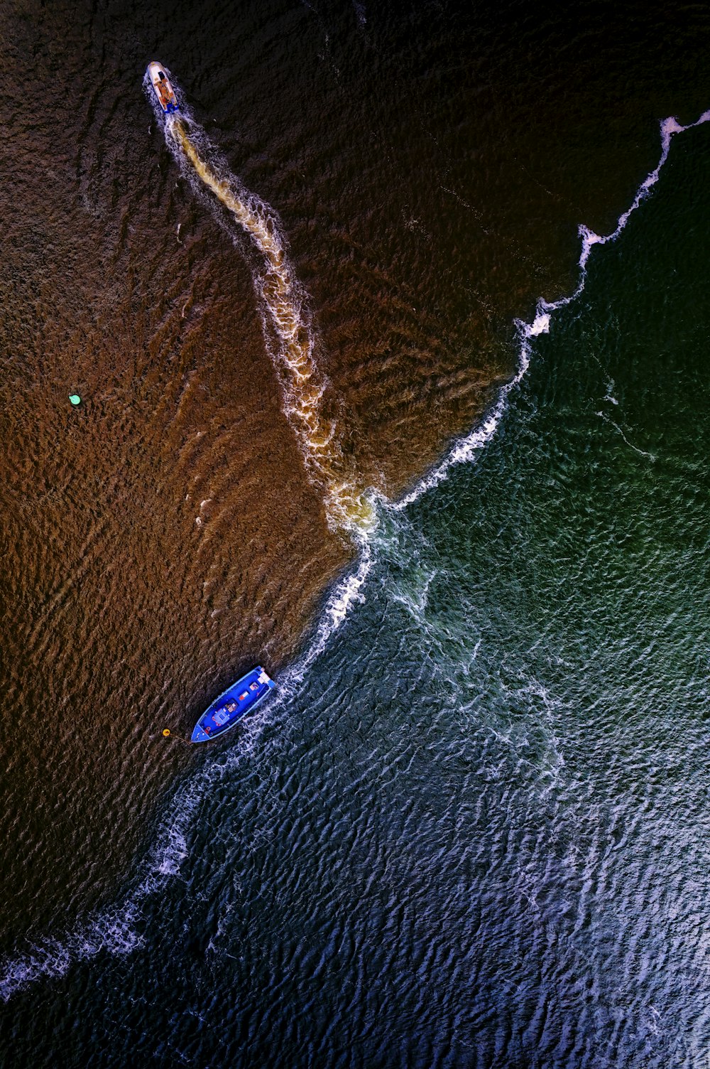 an aerial view of a boat in the water