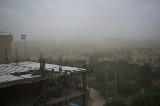 Blurred background of a busy construction site with workers and machinery.