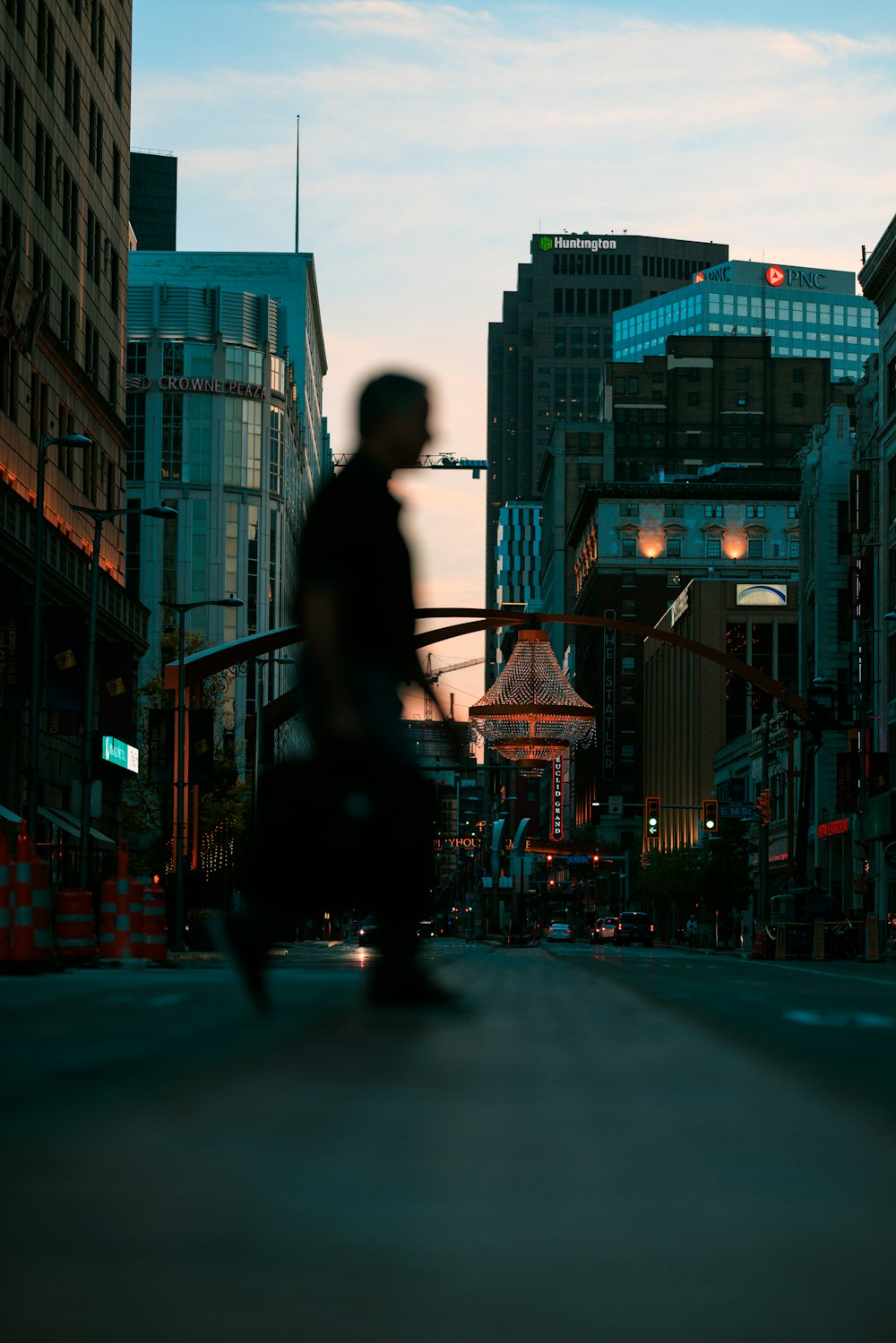 a man riding a skateboard down a street next to tall buildings