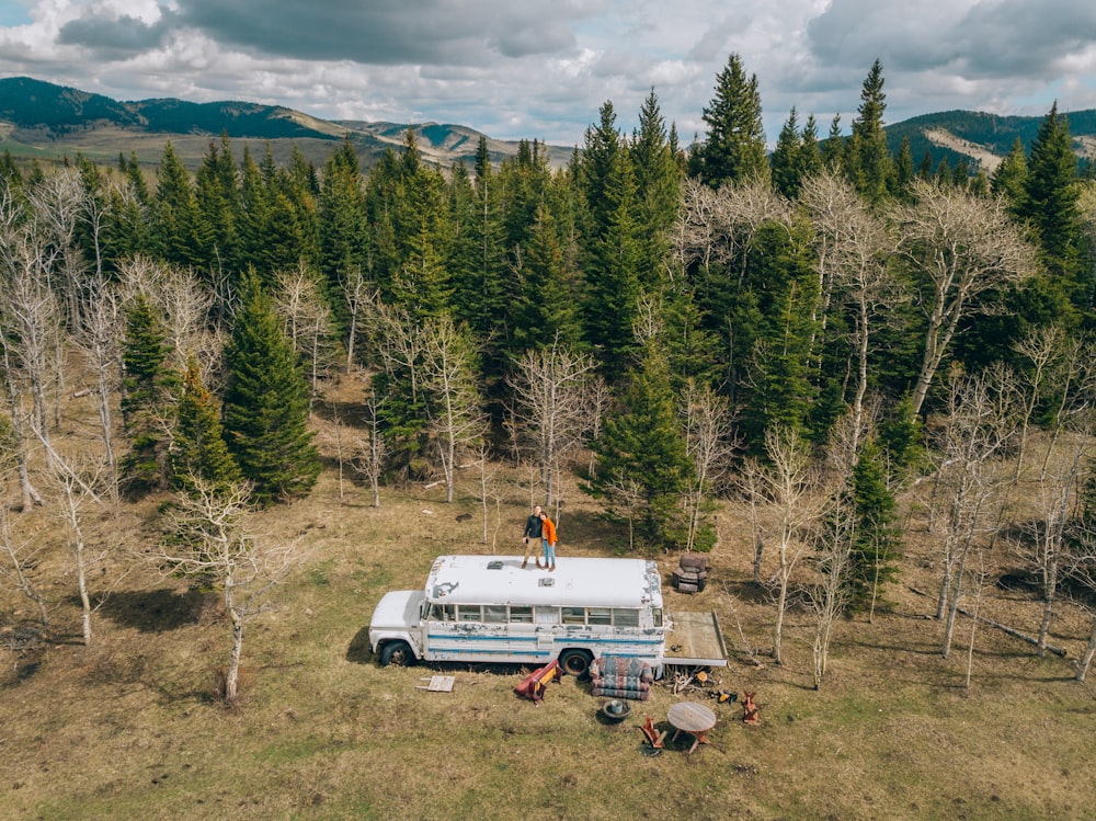 a camper van parked in the middle of a forest