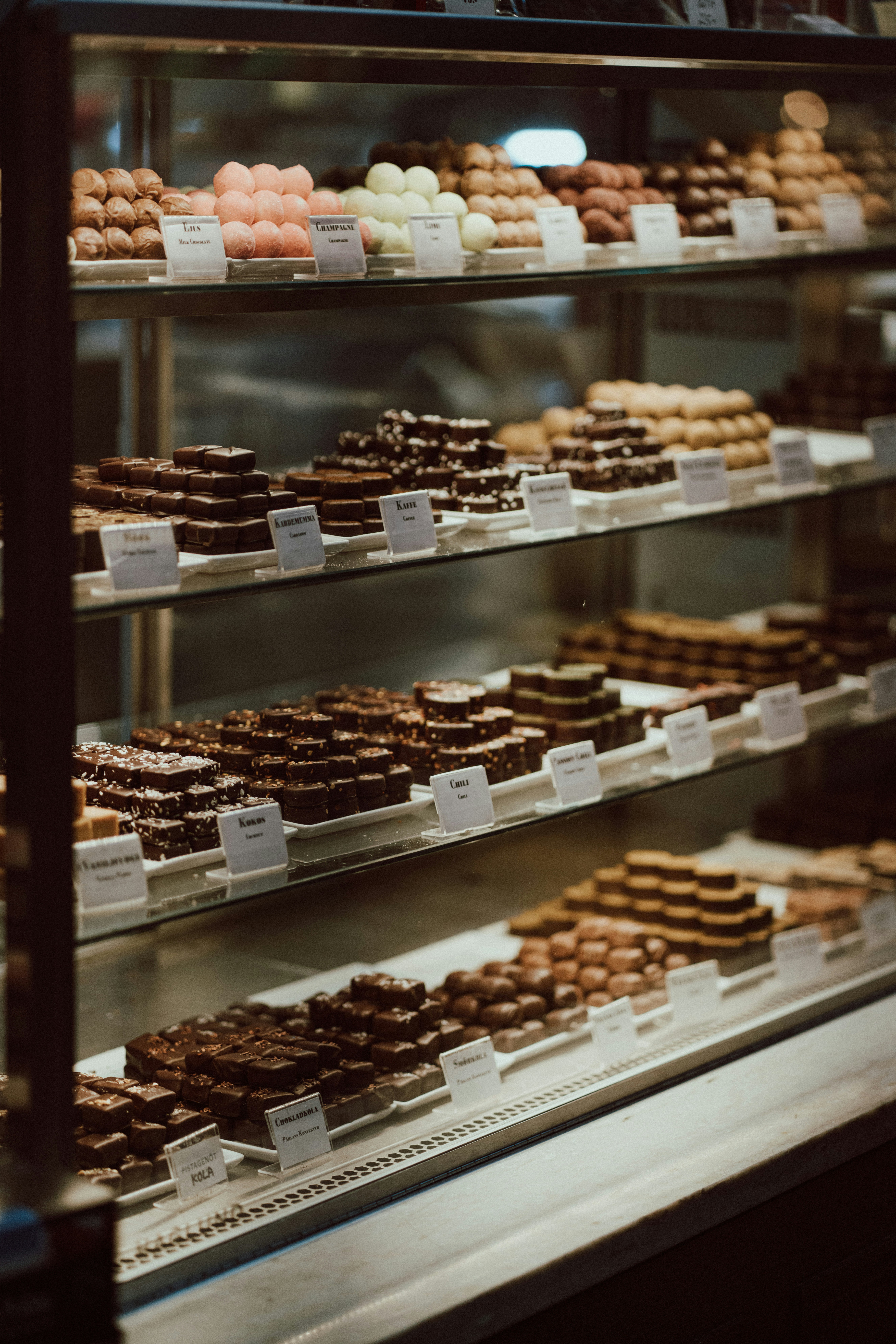 a display case filled with lots of different types of donuts