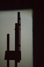 A minimalistic, partially obscured geometric form in muted tones, evoking curiosity.