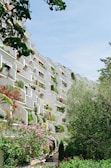 Multifamily housing complex with green terraces and community areas.