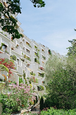 Multifamily housing complex with green terraces and community areas.