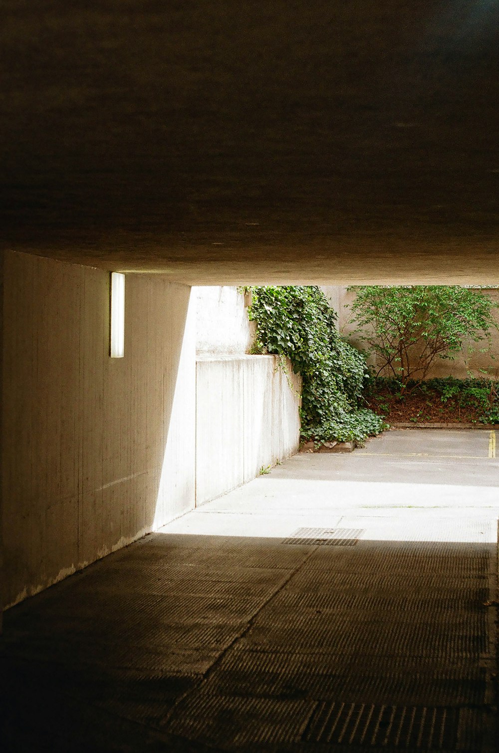 a person sitting on a bench in a tunnel