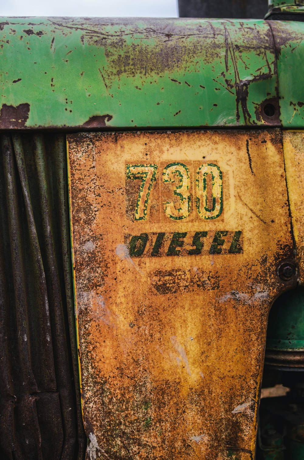 a close up of the front of an old green tractor