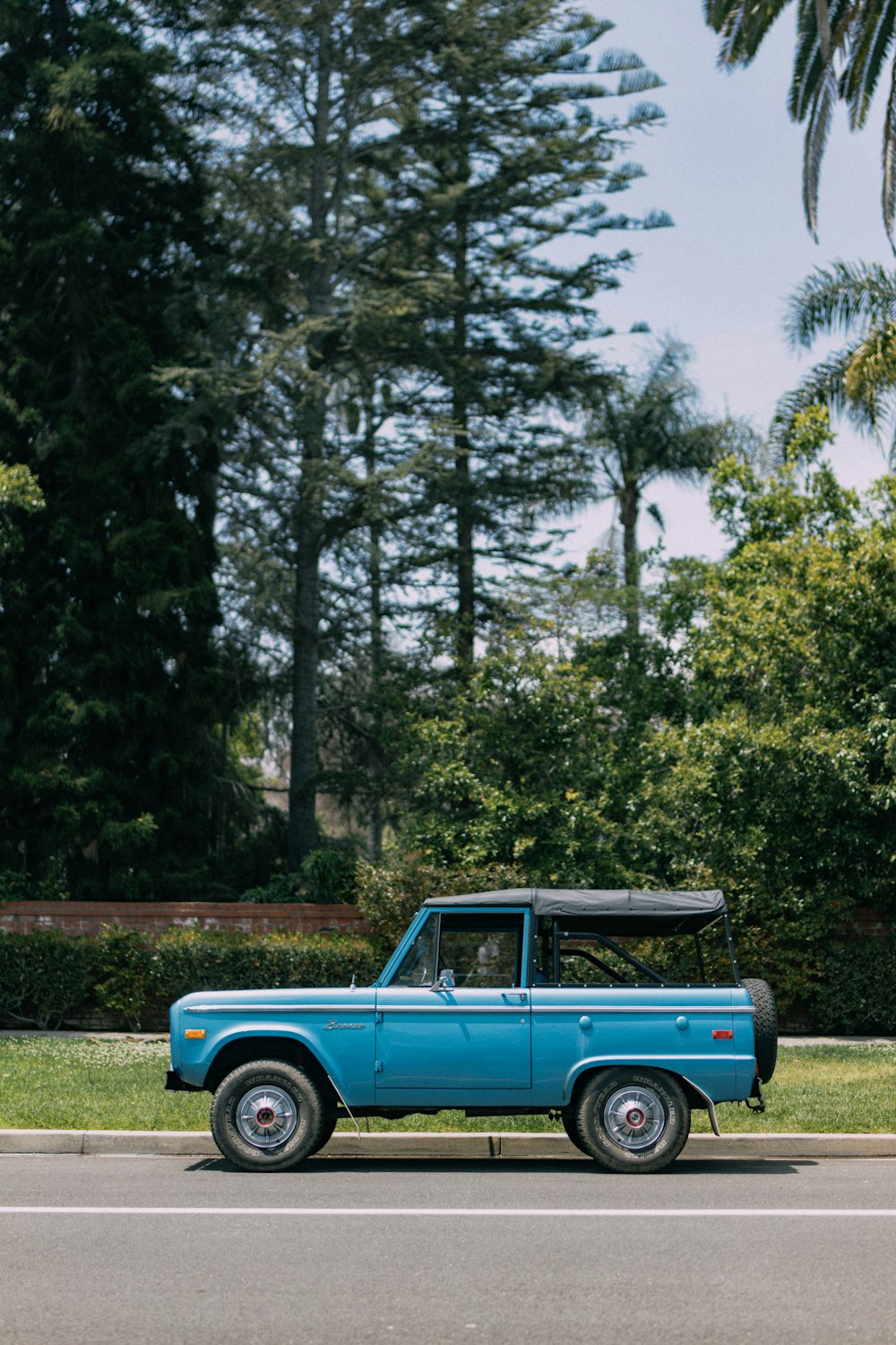 a blue truck parked on the side of the road