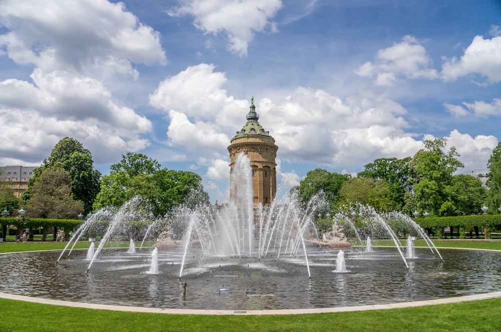 a large fountain in the middle of a park